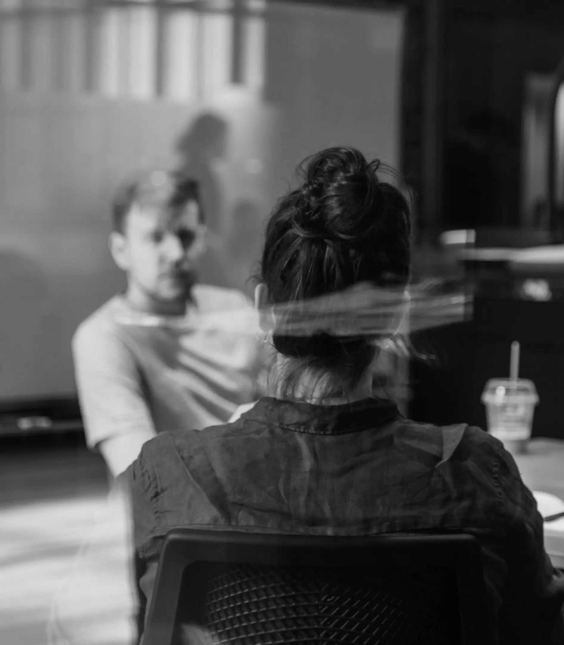 Two people sitting at a conference table.